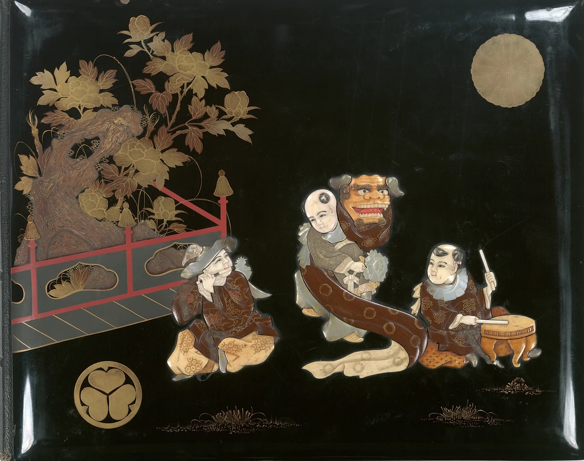 Lacquer cover inlaid with mother-of-pearl, ivory and wood. Front cover depicting two musicians and a dragon mask entertainer. Source: New York Public Library