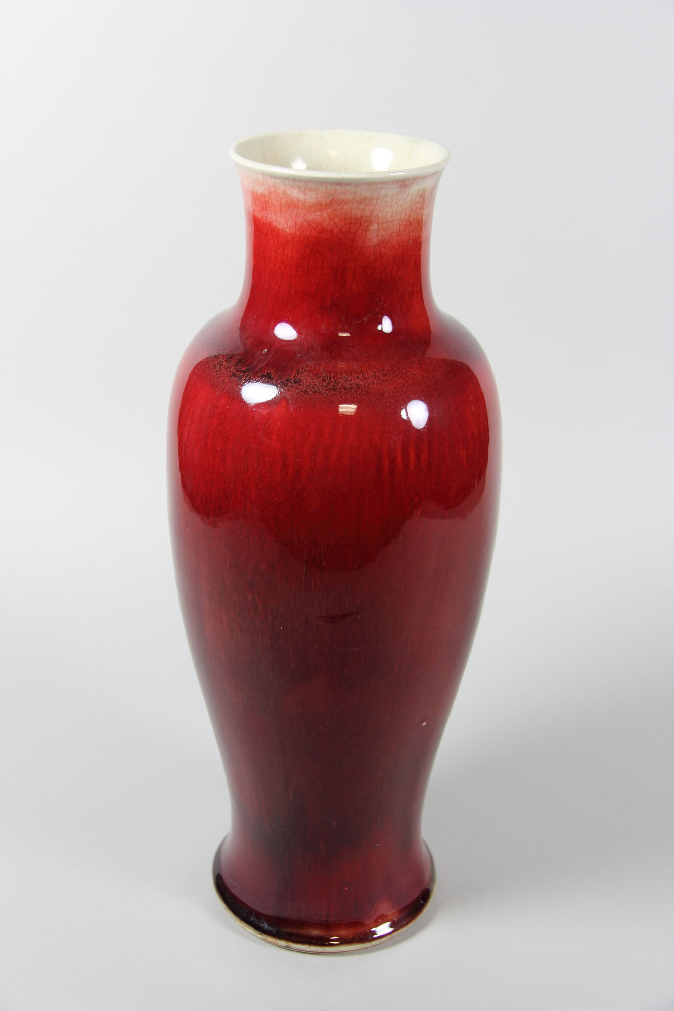 Title: Vase
Period: Qing dynasty (1644–1911), Kangxi period (1662–1722)
Date: late 17th–early 18th century
Culture: China
Medium: Porcelain with ox-blood red glaze (Jingdezhen ware), wooden stand
Dimensions: H. 18 in. (45.7 cm)
Classification: Ceramics
Credit Line: Bequest of Benjamin Altman, 1913
Accession Number: 14.40.412